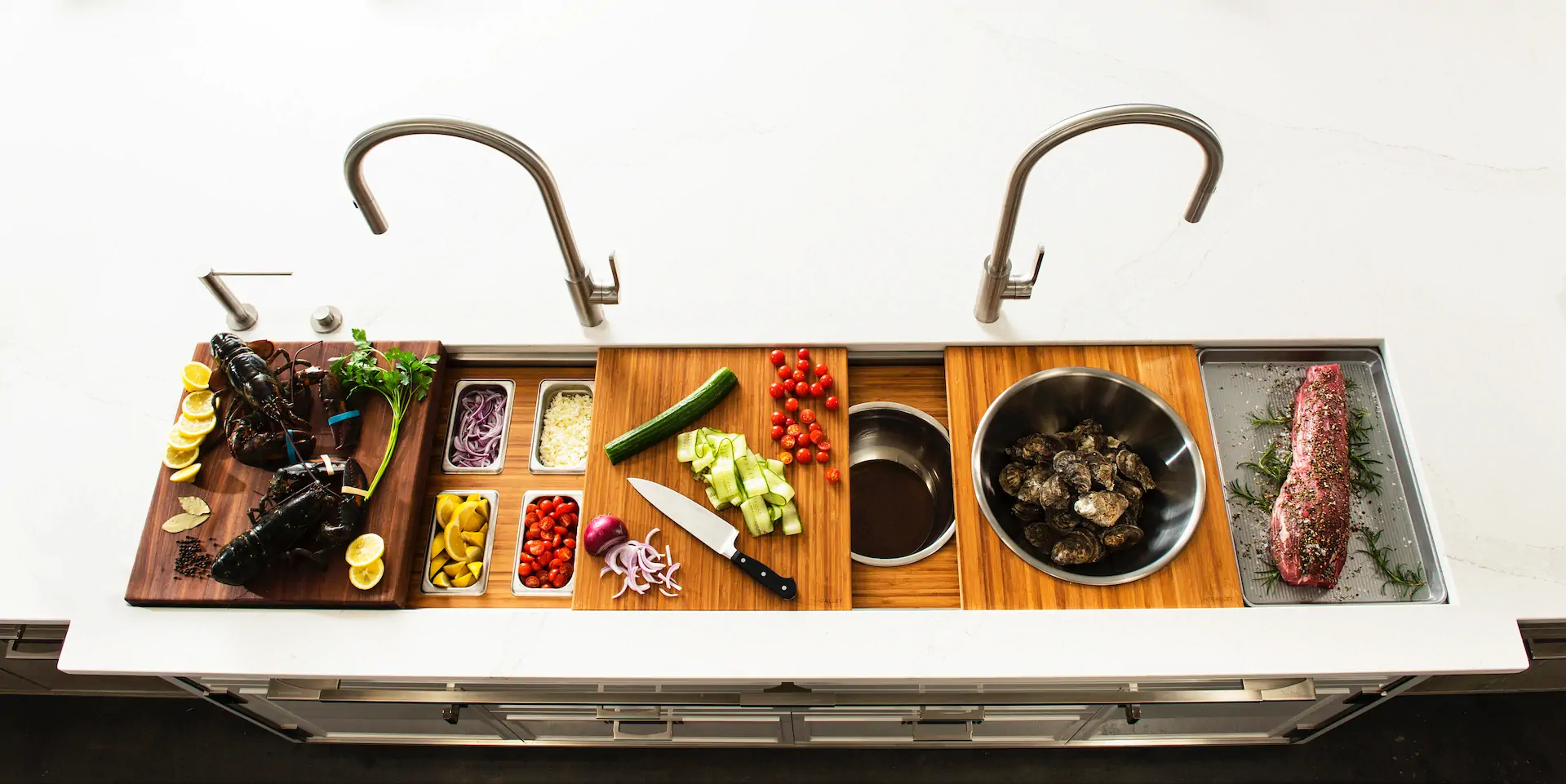 The Galley Workstation with culinary tools arranged across a kitchen sink basin