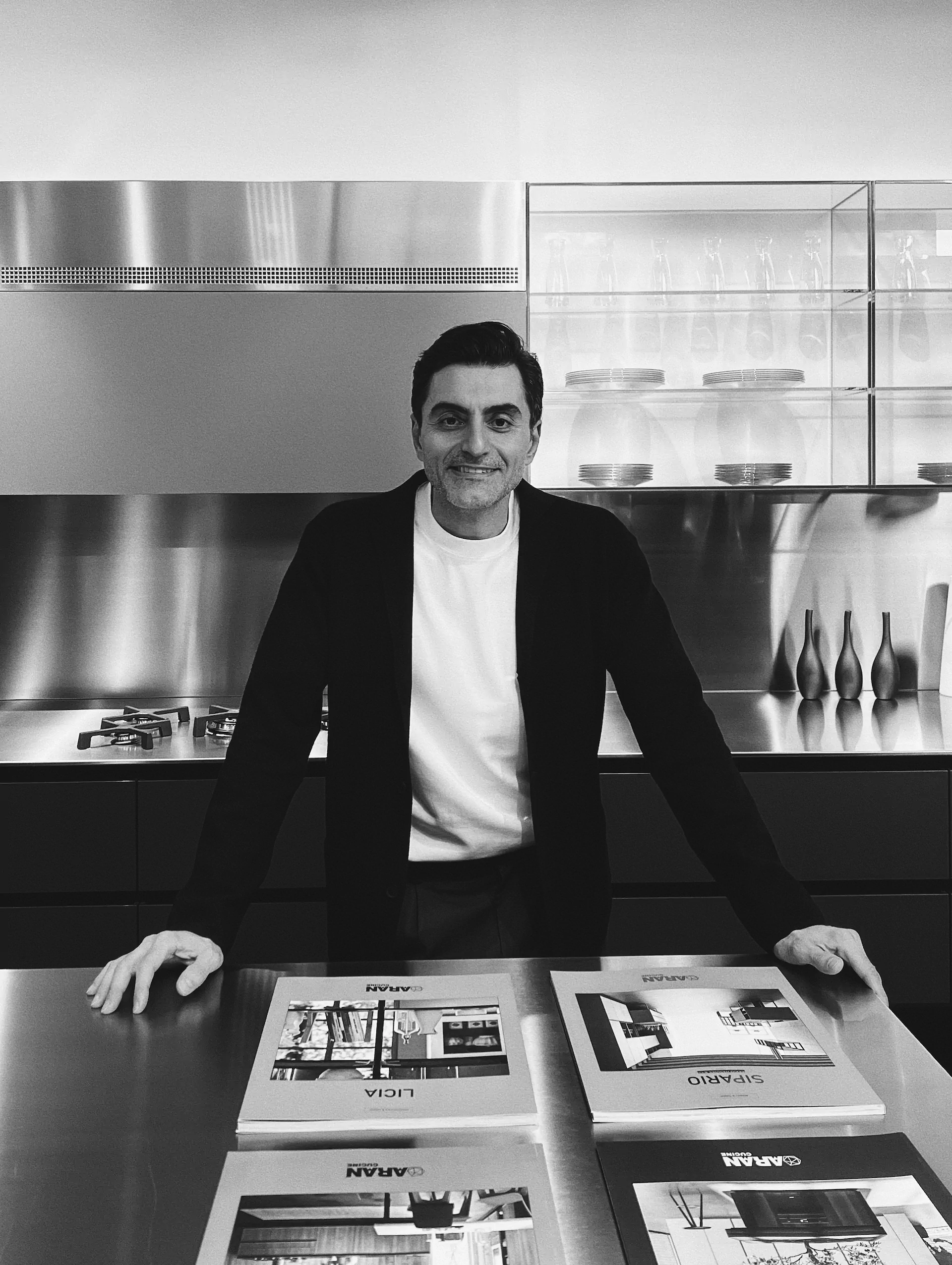 Sam, senior designer at KI Atelier, inside the Vancouver showroom with ARAN catalogues